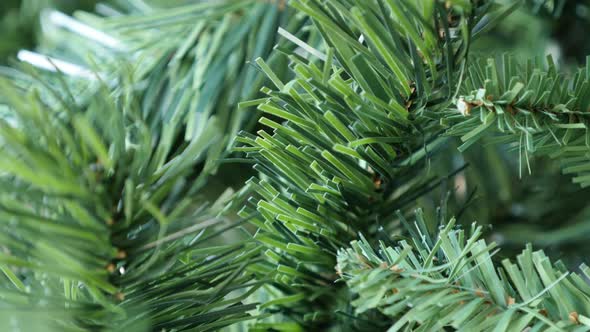 Close-up of artificial green needles on Christmas tree  4K 2160p 30fps UltraHD tilting footage -Deco