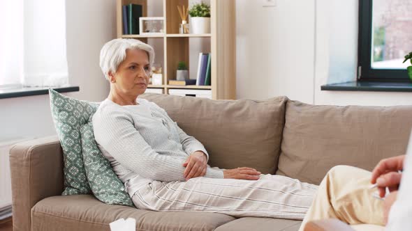 Senior Woman Patient Talking To Man Psychologist