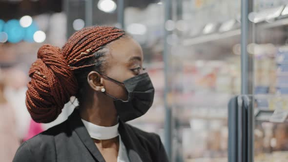 Closeup Portrait African American Womanin Medical Mask Girl Consumer Female Shopper Looks at Shop