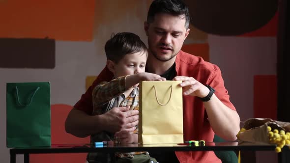 Father and son prepare a gift for a mother day