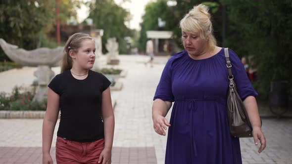 Fat Woman with Daughter Walking at the City