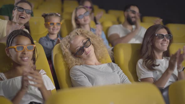 Angle View of Sleeping Caucasian Woman in 3d Glasses Sitting in Cinema As People Clapping and