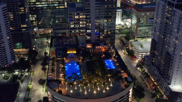 Cinematic Overhead View on Rooftop Bar and Pool with Palm Trees Fireplaces Miami alt