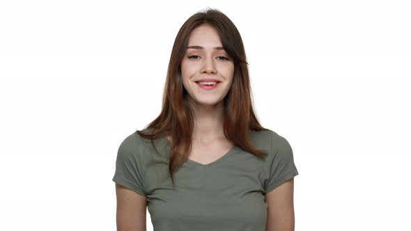 Portrait of Attractive Woman with Long Brown Hair Wearing Basic Tshirt Smiling and Expressing