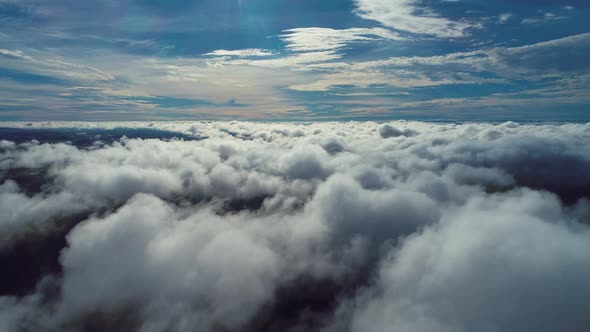 Above the clouds. Sunrise foggy morning.