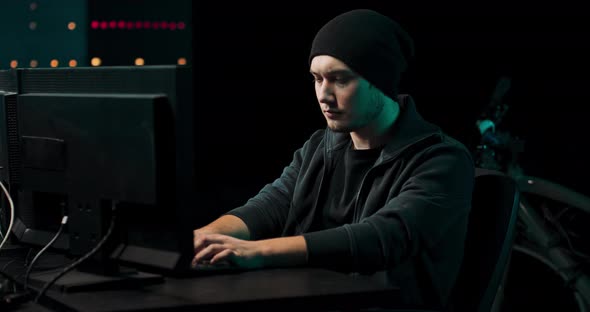 Young Professional Male Hacker Using Keyboard Typing Bad Data Into Computer Online System and