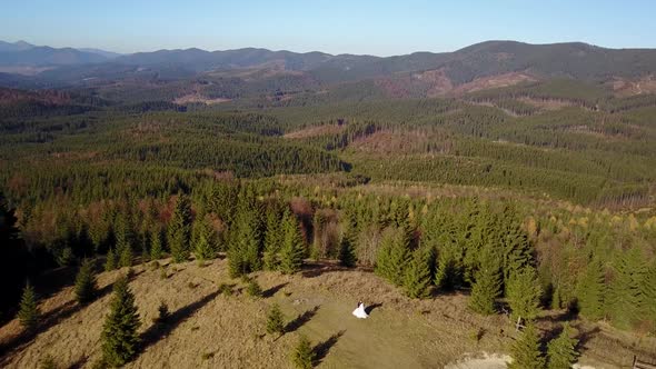 Aerial View Beautiful Couple Walking Against in the Mountains of the Carpathians