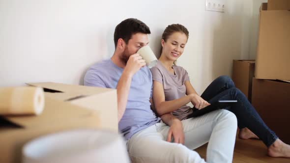 Happy Couple with Tablet Pc at New Home 10