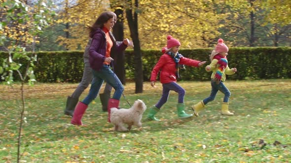 Family Running Through Park