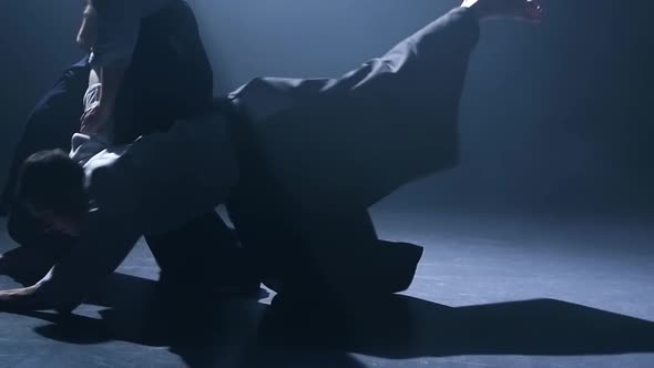 Fight Between Two Aikido Fighters in the Dojo. Close Up View of the Legs. Slow Motion.