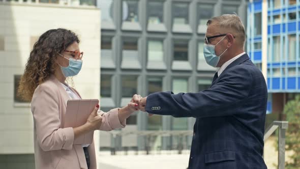 Business Partners Greet Each Other on the Street