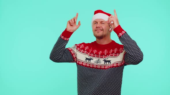 Man in Christmas Sweater Listening Music Via Earphones Dancing Disco Fooling Around Having Fun