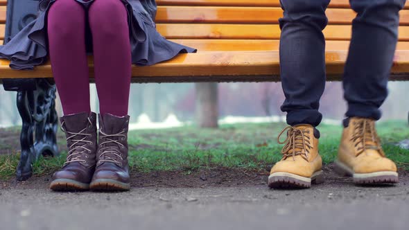 Portrait Cropped Legs of Young Man and Woman Expressing Romantic Feelings While Sitting Together on