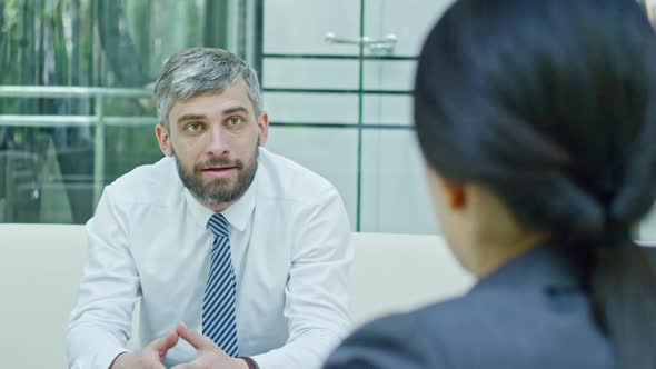 Cheerful Businessman Talking with Businesswoman