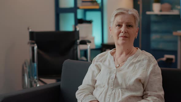 Portrait of Elderly Woman Looking at Camera in Living Room