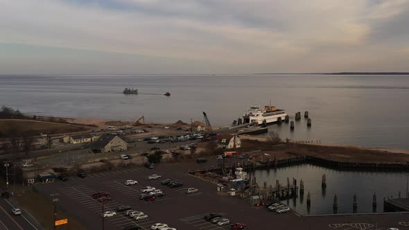 an aerial shot of the Orient Point ferry docked, taking on vehicles and passengers. It was a cloudy