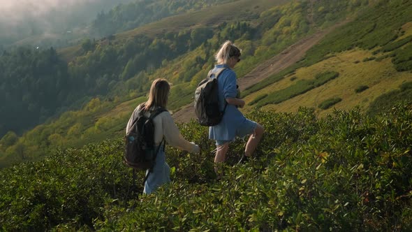 Two High School Girls is Traveling at Nature in Mountains