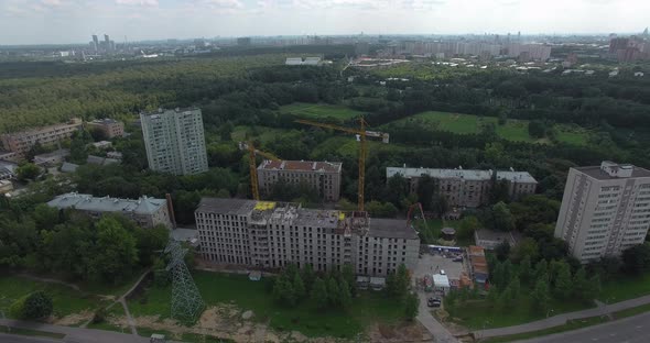 A Residential District with Hoisting Cranes