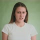 Woman Looks Disgustedly Into Camera Standing on Green - VideoHive Item for Sale