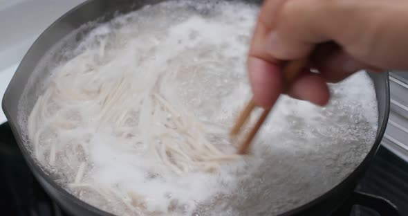 Cook with japanese soba in the kitchen