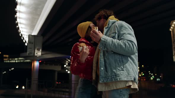 Joyful Couple Kissing on Urban Street