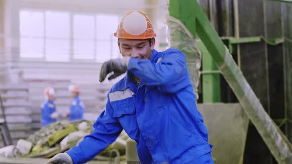 Joyful factory worker at workplace