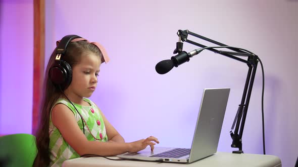 Influencer girl recording podcast and video call in her room with microphone and laptop