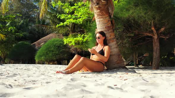 Ladies together happy together on perfect tourist beach break by blue green ocean and white sand bac