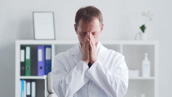 Professional medical doctor working in hospital office using computer technology.