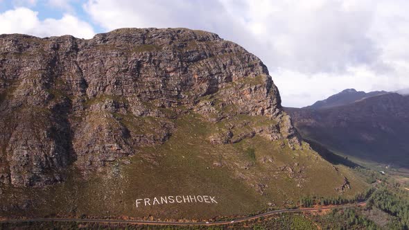Aerial arc shows scenic route of Franschhoek mountain pass, South Africa