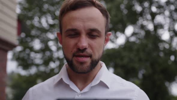 Close Up View of Young Man Who Talks Outdoor