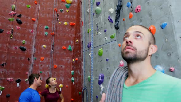 Confident man standing with rope in fitness studio 4k