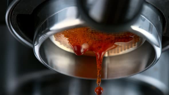 Super Slow Motion Macro Shot of Dripping Fresh Espresso Coffee From Lever Machine at 1000 Fps