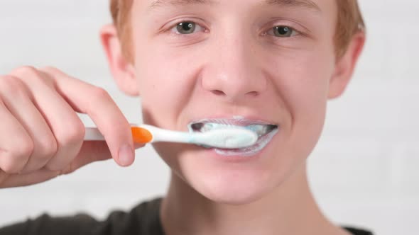 Portrait Smiling Red Haired Teen Boy with Toothbrush