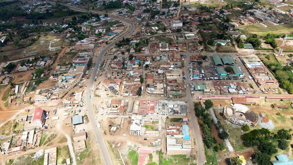 Rural settlement Africa- Aerial flyover poor Kibera Slum and modern skyline of Nairobi in background