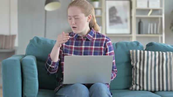 Young Woman Working on Laptop And Sneezing