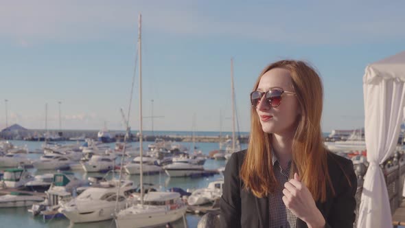 Beautiful Young Girl in Port on Vacation.