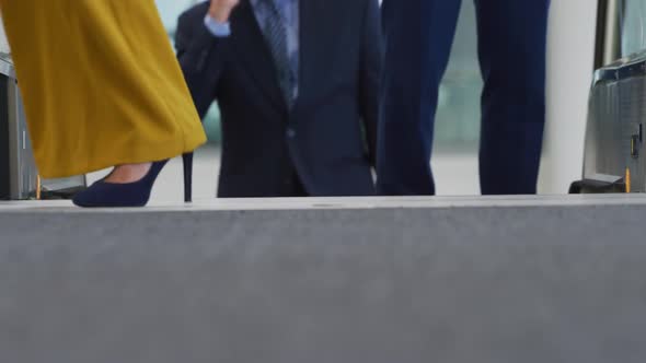 Business people on an escalator in a modern building