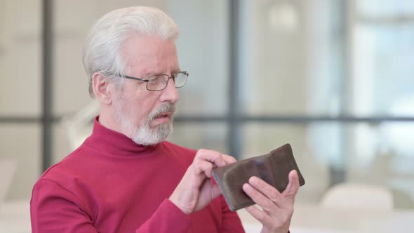 Old Man Checking Empty Wallet at Work