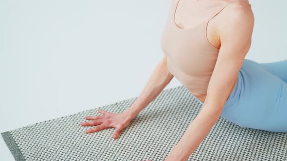 Close-up of young woman with exercise mat for yoga training