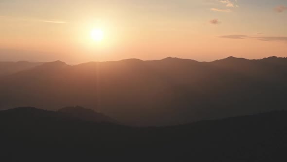 Orange Sunset Over Mountain Range Aerial View