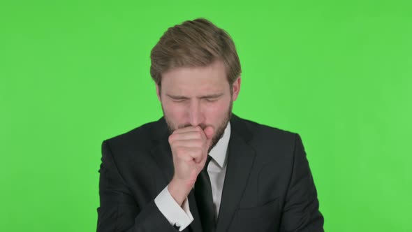 Young Businessman Coughing on Green Background
