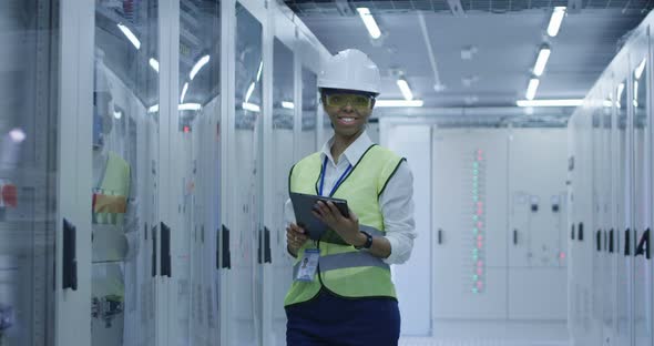 Smiling Black Woman Working in Solar Plant Center