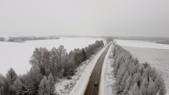 Aerial Footage Flying Over a Winter Route in the Middle of Snowcovered Trees