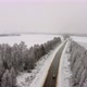 Aerial Footage Flying Over a Winter Route in the Middle of Snowcovered Trees - VideoHive Item for Sale