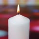White Candle Is Burning On Colorful Background.  Zooming In - VideoHive Item for Sale