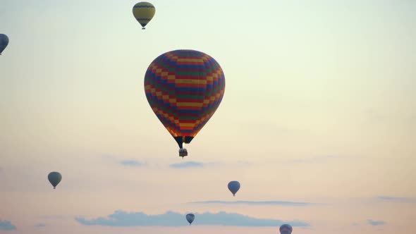 Hot-air balloons flying over the mountain landsape of Cappadocia