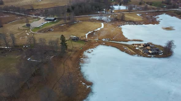 Historical Wooden Buildings on Small Island in the Frozen Lake Araisi in the Winter