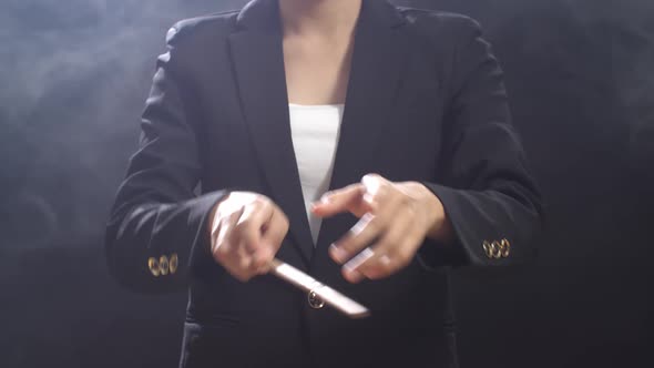 Close Up Of Conductor's Hands Holding A Baton And Moving In The Black Studio