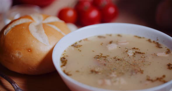 Soup In Bowl Amidst Various Ingredients Assorted On Wooden Table